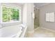 Bathroom featuring a garden tub with large windows and a glass shower at 2036 E Foxwood Ct, Indian Land, SC 29707