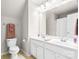Bathroom featuring dual sinks, a toilet, and a shower-tub combo at 2036 E Foxwood Ct, Indian Land, SC 29707