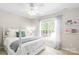 Bright bedroom with a white bed frame, window views and custom shelves at 2036 E Foxwood Ct, Indian Land, SC 29707