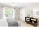 Bedroom with a white bed frame, large windows and a wooden cabinet at 2036 E Foxwood Ct, Indian Land, SC 29707