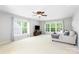Bright bonus room features natural light from three windows and neutral tones, with a comfy couch at 2036 E Foxwood Ct, Indian Land, SC 29707
