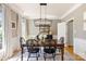 Formal dining room with hardwood floors, modern light fixture, and ample seating at 2036 E Foxwood Ct, Indian Land, SC 29707