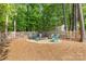 Backyard area featuring a cozy fire pit surrounded by chairs and a wooded backdrop for relaxation at 2036 E Foxwood Ct, Indian Land, SC 29707