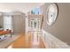 Inviting foyer with hardwood floors, wainscoting, and ample natural light at 2036 E Foxwood Ct, Indian Land, SC 29707