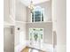 Grand foyer with soaring ceilings, large windows, and elegant chandelier at 2036 E Foxwood Ct, Indian Land, SC 29707