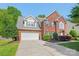 Charming two-story brick home with attached two-car garage and long driveway at 2036 E Foxwood Ct, Indian Land, SC 29707