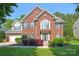 Beautiful two-story brick home with manicured lawn and lush landscaping in a desirable neighborhood at 2036 E Foxwood Ct, Indian Land, SC 29707