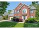 Beautiful two-story brick home with manicured lawn and lush landscaping in a desirable neighborhood at 2036 E Foxwood Ct, Indian Land, SC 29707