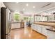 Eat-in kitchen area with stainless appliances, hardwood floors, and natural light at 2036 E Foxwood Ct, Indian Land, SC 29707