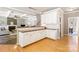 Kitchen area with white cabinets, granite counters, and hardwood floors at 2036 E Foxwood Ct, Indian Land, SC 29707