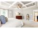 Spacious bedroom with a large bed, tray ceiling, updated ceiling fan, and neutral colored walls at 2036 E Foxwood Ct, Indian Land, SC 29707