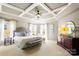Spacious main bedroom with coffered ceilings, natural light, and sitting area at 2036 E Foxwood Ct, Indian Land, SC 29707