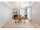 Well-lit office with hardwood floors, neutral paint, and stylish light fixture at 2036 E Foxwood Ct, Indian Land, SC 29707