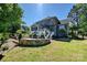 Large two-story home featuring an outdoor patio with built-in stone wall at 205 Commodore Ct, Belmont, NC 28012