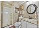 Bathroom featuring a glass-enclosed shower, decorative tile, white vanity with granite countertop, and a round mirror at 205 Commodore Ct, Belmont, NC 28012