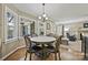 Charming breakfast nook with a round table, four chairs, and a chandelier with views of the backyard at 205 Commodore Ct, Belmont, NC 28012
