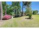 Well-maintained home with mature trees and a lush green lawn in a peaceful setting at 205 Commodore Ct, Belmont, NC 28012