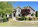 Charming home with a landscaped yard, circular walkway, and inviting entrance at 205 Commodore Ct, Belmont, NC 28012