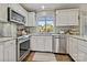 Modern kitchen featuring stainless steel appliances, granite countertops, and ample cabinet space, creating a chef-friendly environment at 205 Commodore Ct, Belmont, NC 28012