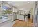 Bright kitchen featuring white cabinets, granite countertops, stainless steel appliances, and hardwood floors at 205 Commodore Ct, Belmont, NC 28012