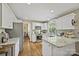 Well-lit kitchen with stainless steel appliances, granite countertops, and a view of the outdoors, providing an inviting atmosphere at 205 Commodore Ct, Belmont, NC 28012
