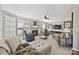 Spacious living room featuring a stone fireplace, plush seating, and a ceiling fan at 205 Commodore Ct, Belmont, NC 28012