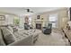 Cozy living room with a stone fireplace, comfortable seating, and natural light from the windows at 205 Commodore Ct, Belmont, NC 28012