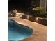 Beautiful pool at night with paver deck, outdoor lighting, and lush landscaping at 205 Commodore Ct, Belmont, NC 28012