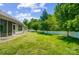 Lush backyard features a sprawling lawn and a white fence for added privacy at 2113 London Ln, Belmont, NC 28012