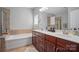 Bathroom with double vanity, tub, and tile accents at 2113 London Ln, Belmont, NC 28012