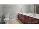 Bright bathroom features a double sink vanity with wood cabinets and a large mirror at 2113 London Ln, Belmont, NC 28012