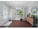 Bright dining room with dark hardwood floors, stylish chandelier, and sliding glass door to exterior at 2113 London Ln, Belmont, NC 28012