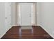 Welcoming foyer featuring rich, dark hardwood flooring and a classic checkered mat, setting a stylish tone at 2113 London Ln, Belmont, NC 28012