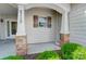 Charming front porch with stone accents and shingle siding details, enhancing the home's curb appeal at 2113 London Ln, Belmont, NC 28012
