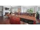Open-concept kitchen featuring a breakfast bar, stainless steel appliances, and dark wood cabinetry for a functional design at 2113 London Ln, Belmont, NC 28012