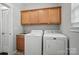 Convenient laundry room with cabinets, sink, washer, and dryer at 2113 London Ln, Belmont, NC 28012