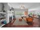 Cozy living room with a brick fireplace, large windows, and a comfortable leather sofa, perfect for relaxation at 2113 London Ln, Belmont, NC 28012