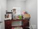 Functional room with a desk overflowing with boxes, and a small window at 2113 London Ln, Belmont, NC 28012