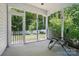 Relaxing screened porch with serene view of the backyard and mature trees at 2113 London Ln, Belmont, NC 28012