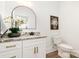 Elegant half-bathroom featuring granite countertops, modern fixtures, and a decorative mirror at 2133 Tite Rd, Stanfield, NC 28163