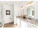 Modern bathroom with double vanities, granite countertops, gold fixtures, a stylish mirror and a glass shower at 2133 Tite Rd, Stanfield, NC 28163