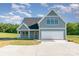 Charming two-story home with gray siding, white trim, and a two-car garage at 2133 Tite Rd, Stanfield, NC 28163