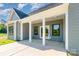 Covered patio with white columns and exterior with black window frames at 2133 Tite Rd, Stanfield, NC 28163