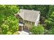 Aerial view of a two-story home with a two car garage, lush trees, and a large roof at 2417 Labelle Dr, Waxhaw, NC 28173