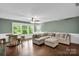 Brightly lit basement featuring a projector screen and comfortable seating area at 2417 Labelle Dr, Waxhaw, NC 28173