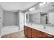 Full bathroom with double sinks, soaking tub and neutral tile floors at 2417 Labelle Dr, Waxhaw, NC 28173
