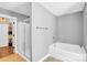 Bathroom with walk-in shower, bathtub, and closet with built-ins at 2417 Labelle Dr, Waxhaw, NC 28173