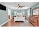 A spacious primary bedroom with ensuite bath, ceiling fan and wood look floors at 2417 Labelle Dr, Waxhaw, NC 28173