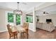 Open-concept dining area with stylish chandelier and access to both living room and deck at 2417 Labelle Dr, Waxhaw, NC 28173