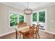 Bright dining room featuring a wood table set and large window views of the backyard at 2417 Labelle Dr, Waxhaw, NC 28173